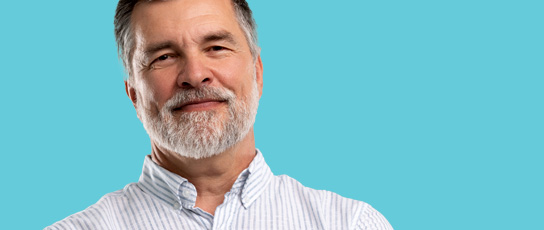 Person in a striped shirt against a blue background.  