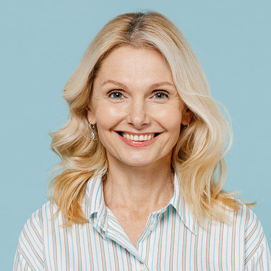 People-Block-1 Woman with blond hair wearing a striped shirt on a blue background.