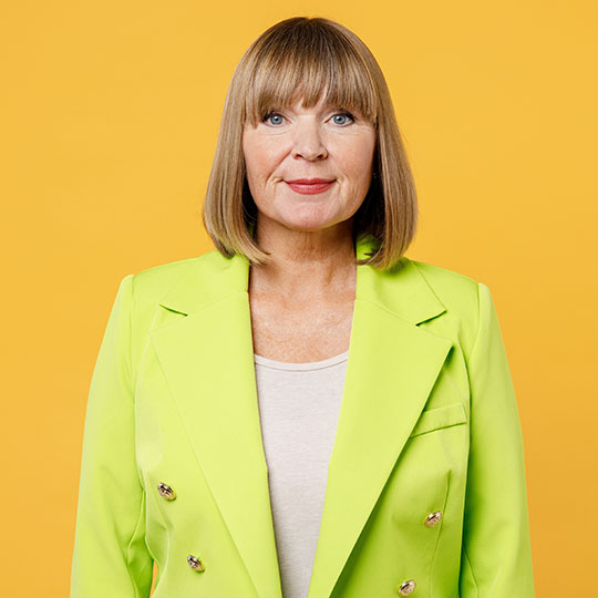 People-Block-27 Person in a bright green blazer against a yellow background.
