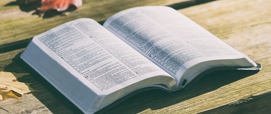 faith544x230 An open bible on a wooden table.